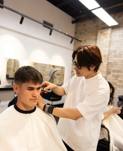 Stylist cutting hair