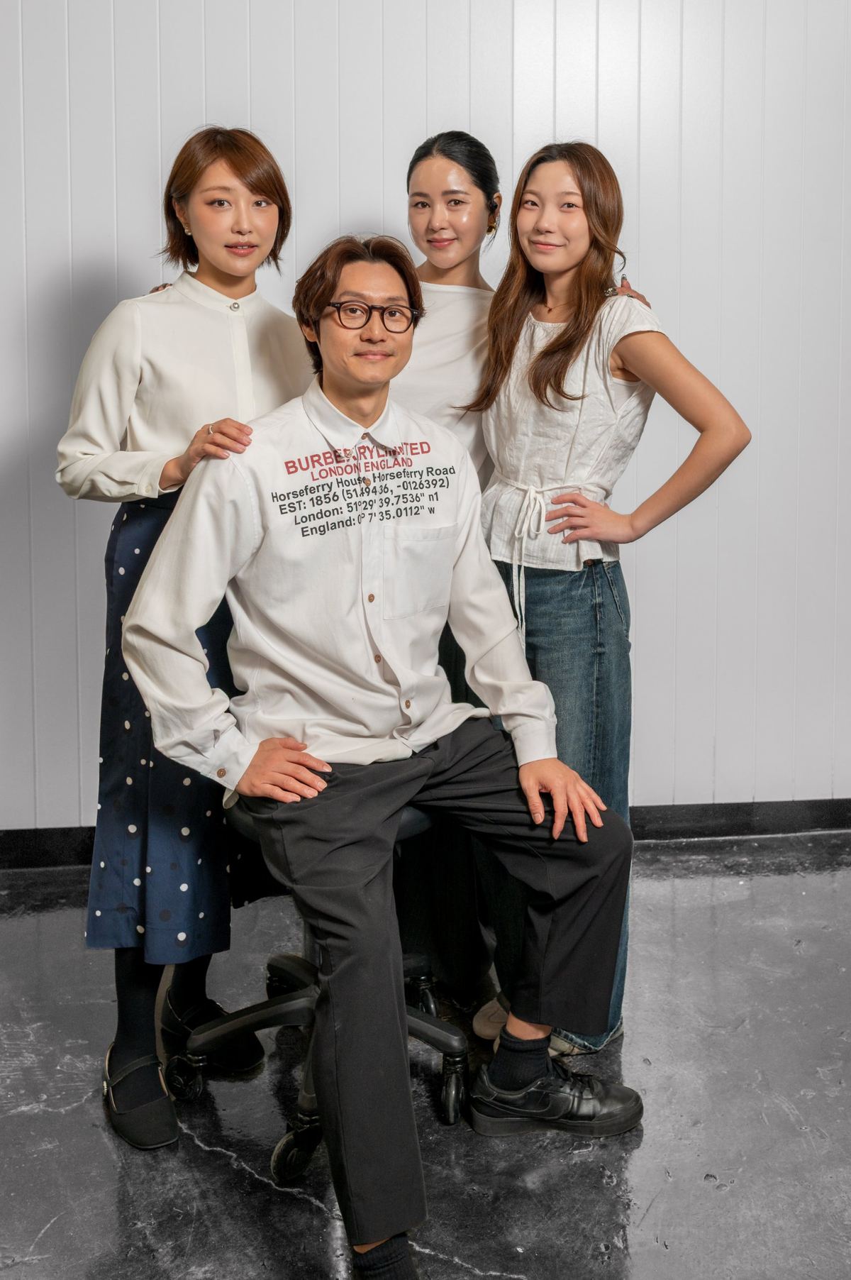 The Seoul Glow team posing together, one seated in front and three standing behind